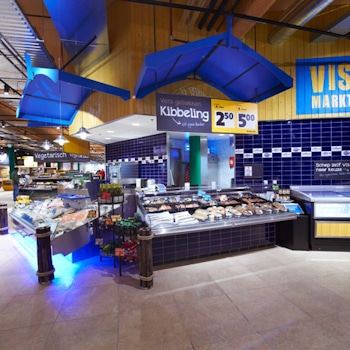 Studio Königshausen's retail design for Jumbo Supermarket in Breda, The Netherlands, aims to enhance the food shopping experience. Jumbo, a family-owned supermarket chain, wanted to elevate food preparation and enjoyment in their stores while maintaining affordability and convenience.